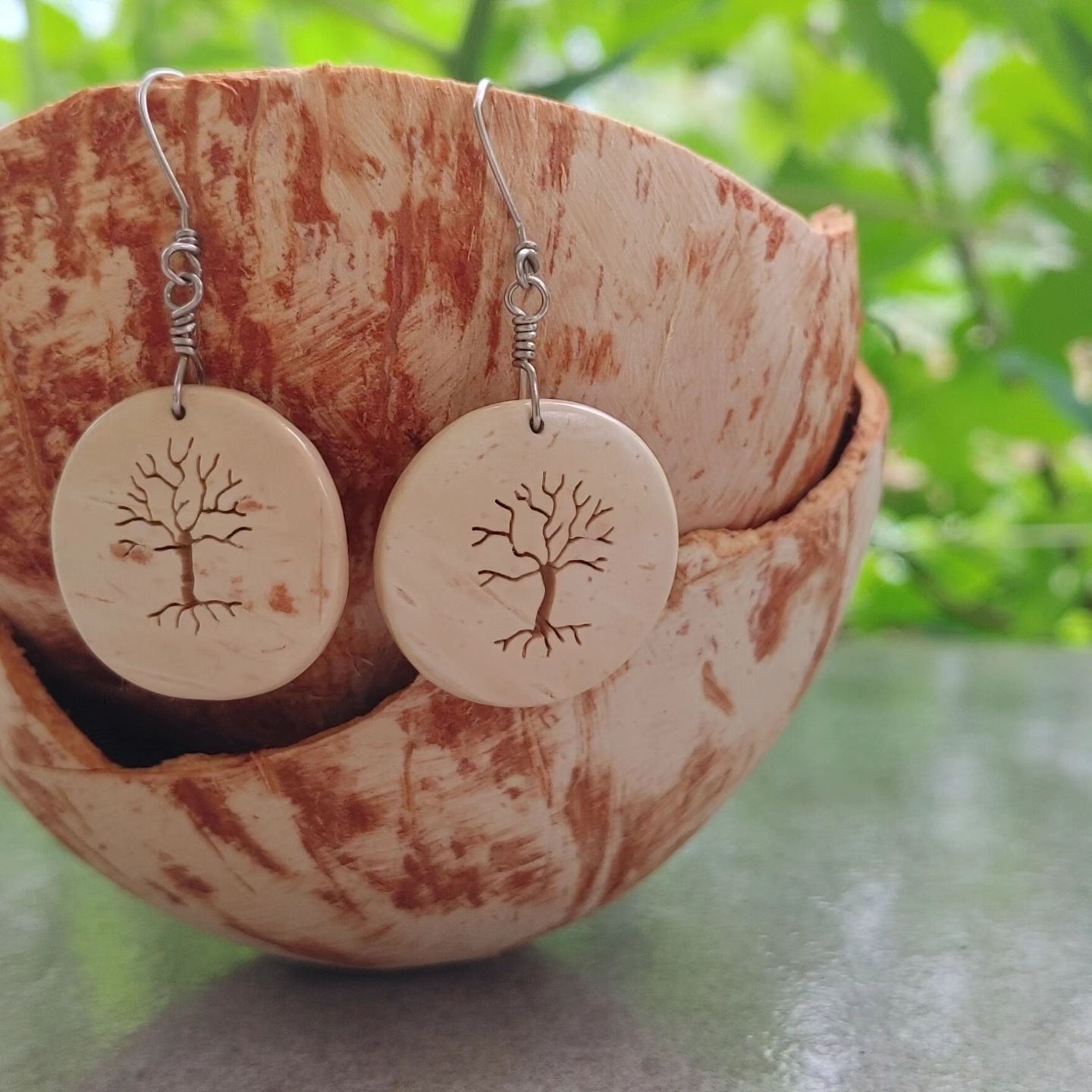 Carved cocnout shell ear rings.