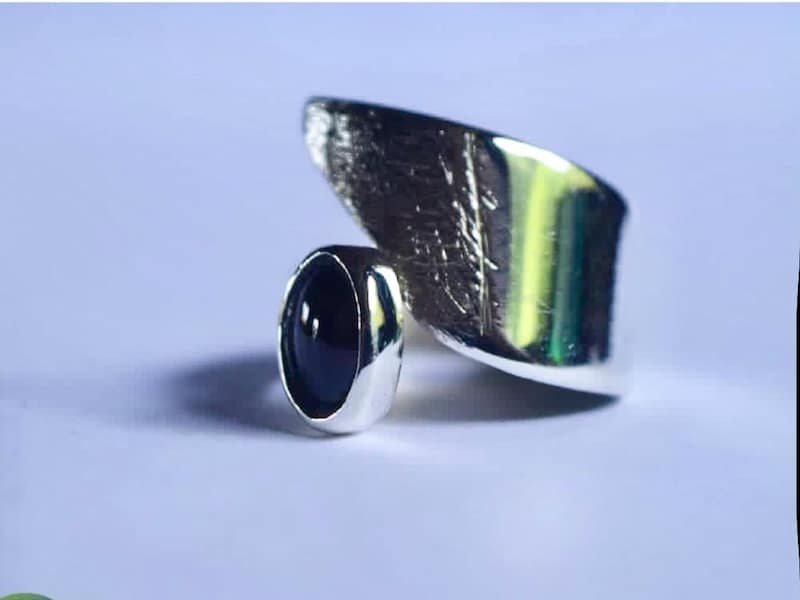 silver rind with dark stone